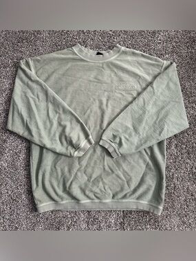 Mackinac Island green crew neck sweater with Mackinac embroidered on left chest
